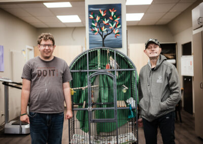 Two persons standing near cage